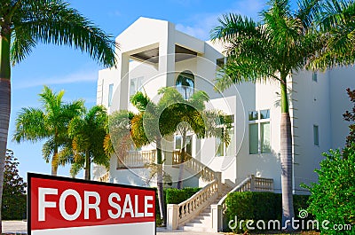 Tropical luxury mansion house w SOLD sign and palm trees Stock Photo