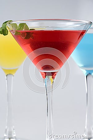 Tropical Martini style drinks with fruit & garnish Stock Photo