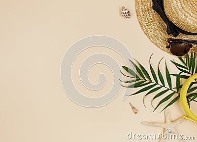 Tropical palm leaves, straw hat, starfish, seashells on beige background. Trendy tropical pattern. Stock Photo
