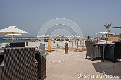 Tropical Paradise. Beach with sun loungers and parasols in Dubai, on the Persian Gulf. The Emirate of RAS al Khaimah. Tinted Stock Photo