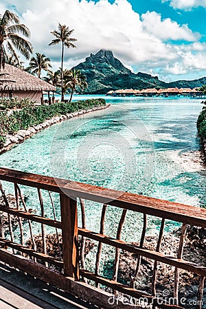 Tropical paradise with turquoise waters, palm trees, and mountains. Bora Bora, French Polynesia Stock Photo