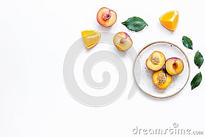 Tropical peach and orange fruits for fresh juice on plates white background top view space for text Stock Photo