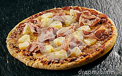 Tropical pineapple with ham and mozzarella pizza Stock Photo