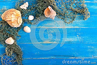 Tropical sea background. Different shells, old fishing net on the blue boards, top view. Free space for inscriptions. Summer theme Stock Photo