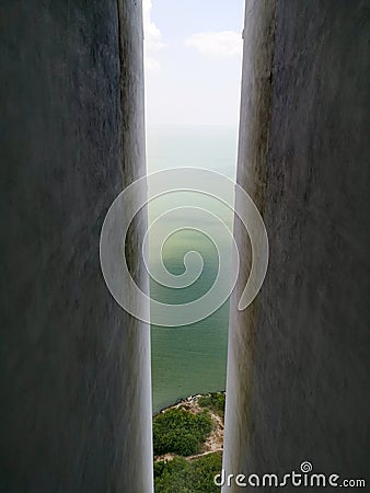 Tropical sea seen from between tall concrete walls Stock Photo