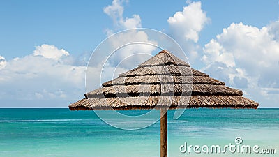 Tropical Seascape with Beach Umbrella & Sunny Sky Stock Photo