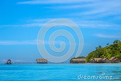 Tropical Stilt Huts and a Long Wooden Pier Stock Photo