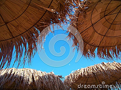 Tropical Straw Beach Umbrellas Stock Photo