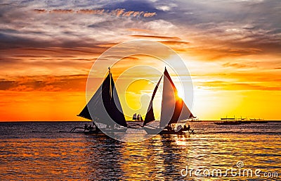 Tropical sunset and silhouette of sailing boats in Boracay island. Editorial Stock Photo