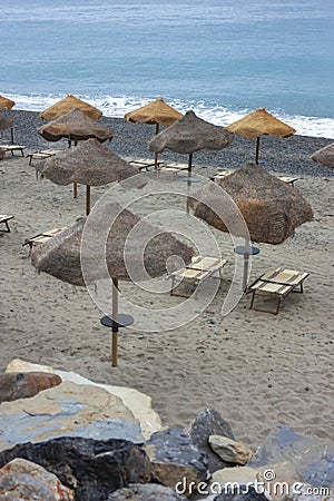 Tropical umbrella on Palinuro beach in Campania, Italy to indicate a tourism concept Stock Photo