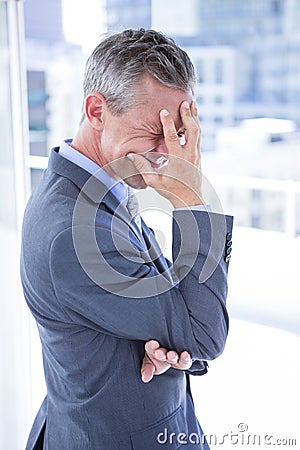 Troubled businessman holding his head Stock Photo