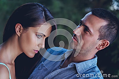 Troubled couple hugging in the park Stock Photo