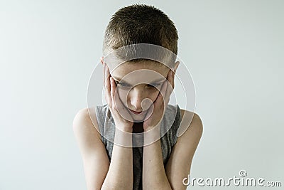 Troubled Young Boy with Head and Hands Stock Photo