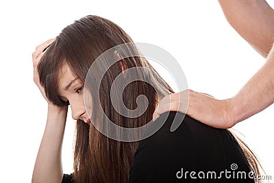 Troubled young girl comforted by her boyfriend. Stock Photo