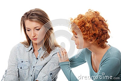 Troubled young girl comforted by her friend Stock Photo
