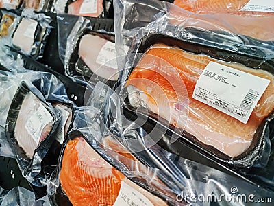 Trout fillet and other varied fish sold in individual trays in the fish market of the French Editorial Stock Photo