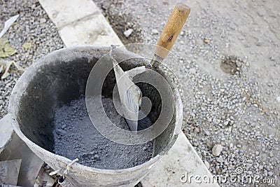 Trowel and bucket with cement Stock Photo