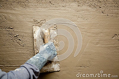 Trowel with glove hand plastering cement mortar Stock Photo