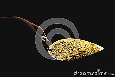 Trowel isolated on Black background. Sand and cement mixed on the trowel, Cement or mortar on the trowel in a hand.Cement Trowel C Stock Photo