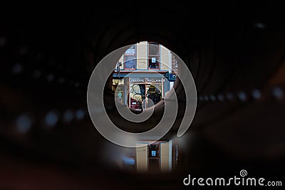 Troy NY USA - Local business and cafe view through pipeline artwork. Editorial Stock Photo