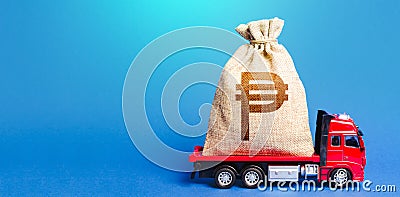 Truck is carrying a big philippine peso money bag. Investment. Anti-crisis measures of government. Attracting large funds to the Stock Photo