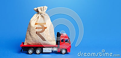 Truck is carrying a huge indian rupee money bag. Great investment. Attracting large funds to the economy for subsidies, support Stock Photo