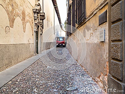 Truck drive on narrow medieval street in Bergamo Editorial Stock Photo