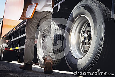 Truck Driver is Checking the Truck`s Safety Maintenance Checklist. Lorry. Inspection Semi Truck Wheels and Tires. Freight Trucks. Stock Photo