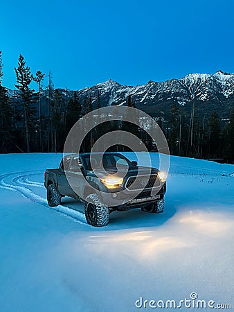 Truck Driving on Snow in Blue Hour Editorial Stock Photo