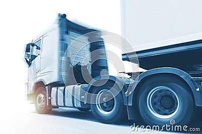 Truck Fast Speeding Motion. Semi Trailer Truck Driving on the Raod. Shipping Trucks. Lorry Tractor Industry Freight Truck Logistic Stock Photo