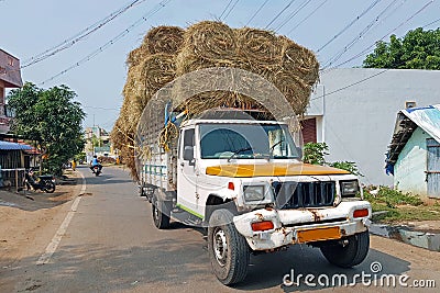 Truck full of hay bales in the streets of Tiruvanamalai India Editorial Stock Photo