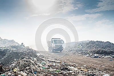 Truck at the garbage dump full of smoke, litter, plastic bottles,rubbish and trash at the Thilafushi local tropical island Stock Photo