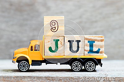 Truck hold block in word 9jul on wood background Concept for date 9 month July Stock Photo