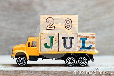 Truck hold block in word 29jul on wood background Concept for date 29 month July Stock Photo