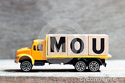 Truck hold block in word MOU Abbreviation of memorandum of understanding on wood background Stock Photo
