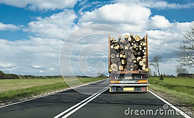 A truck on motorway transporting logs Stock Photo