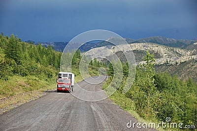 Truck at mountain gravel road Kolyma highway at Russian outback Editorial Stock Photo