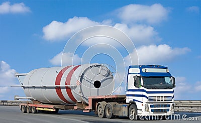 Truck moves huge industrial construction Stock Photo