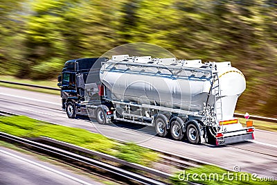 Truck moves on the road at speed Stock Photo