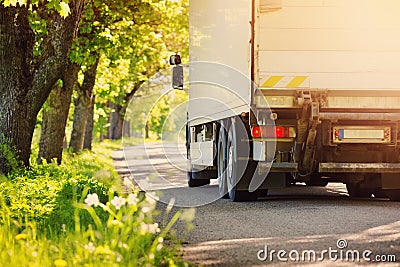 Truck moving on alley in summer Stock Photo