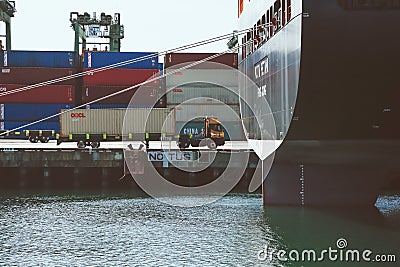 Truck passes ship Editorial Stock Photo