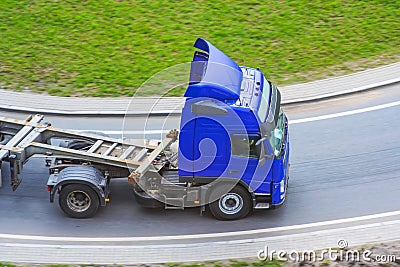 Truck with platform trailer on the bend Stock Photo