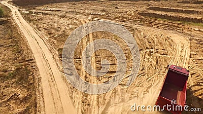 Truck rides on sand quarry road. Scene. Top view of dump truck driving on yellow dirt road in countryside. Large trucks Stock Photo