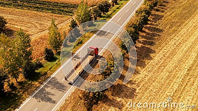 Truck on the road through countryside, aerial view Stock Photo