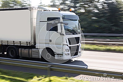 Truck speeding on highway Stock Photo