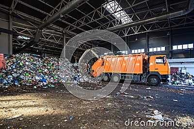 Truck throws garbage at sorting modern waste recycling processing plant. Separate and sorting garbage collection. Recycling and Stock Photo