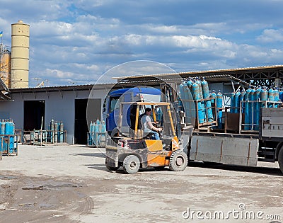 Truck for transportation of gas cylinders. The car delivers gas to shops, restaurants and city dwellers. ForkLift unloading of a t Stock Photo