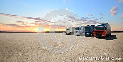 Trucks logistics background with four wagons on the big empty parking. Cargo import or export idea Stock Photo