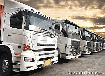 Trucks parked lined up at sunset sky Stock Photo