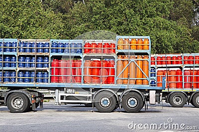 Trucks parked on a street load of propane gas tanks Stock Photo